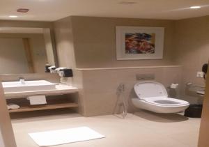 a bathroom with a toilet and a sink at Holiday Inn Express & Suites Bengaluru Old Madras Road, an IHG Hotel in Bangalore