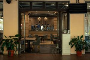 a restaurant with a bar with a table and chairs at Hotel Brilliantin in Sliven +51 photos