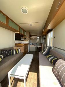 a living room with a couch and a table at suite truck- Natura Eco farm in Natur