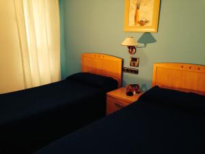 Postel nebo postele na pokoji v ubytování Hostal Meseguer