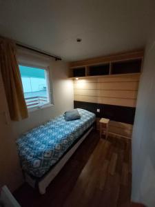 a small bedroom with a bed and a window at détente au cœur de la ferme in Lacroix-sur-Meuse