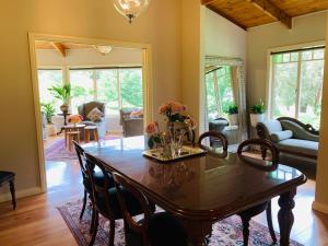 a dining room with a table and chairs at Araluen Boutique Accommodation in Yarra Glen