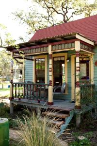 a small house with a deck in the yard at Park Lane Guest House in Austin