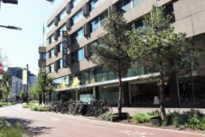 a large building with a bike parked on the side of the street at Crown Hotel Eindhoven Centre in Eindhoven