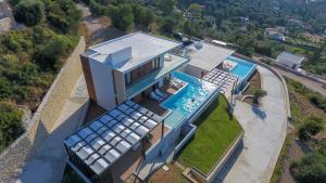 an aerial view of a house with a swimming pool at ioniangems in Lefkada