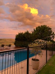a swimming pool with a fence next to at Amazing Views Pet Friendly Bed and Breakfast in Yass