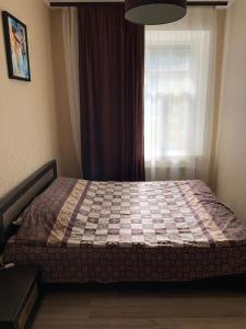 ein Schlafzimmer mit einem Bett vor einem Fenster in der Unterkunft Excellent apartment in the center of Odessa in Odessa