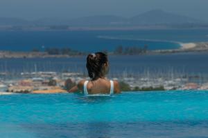 a woman in a swimming pool looking at the water at ioniangems in Lefkada