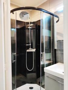 a shower with a glass door in a bathroom at SW House Paris Stade de France CDG in Le Blanc-Mesnil
