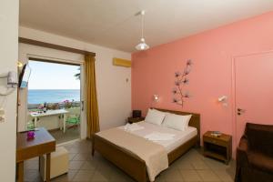 a bedroom with a bed and a view of the ocean at Joanna Studios in Plakias
