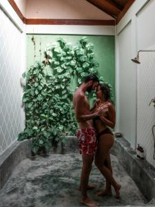 a man and a woman standing in a bath room at Munjoh Ocean Resort - Private Beachfront Luxury Retreat in Havelock in Havelock Island