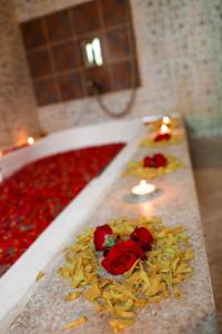 a large bath tub filled with red roses and candles at Munjoh Ocean Resort - Private Beachfront Luxury Retreat in Havelock in Havelock Island