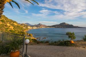 a view of the ocean with mountains in the distance at Joanna Studios in Plakias