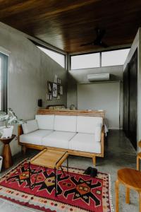 a living room with a white couch and a rug at T Lofts in Seminyak +80 photos