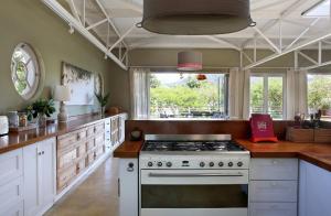 a kitchen with a stove top oven in a room at The Library in Franschhoek