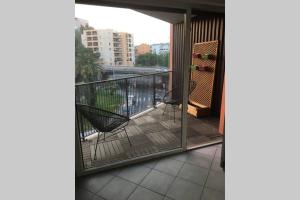 a balcony with chairs and a view of a city at Le Gallienice au cœur de la ville in Nice