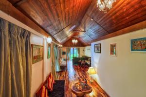 a living room with a wooden ceiling at Munjoh Ocean Resort - Private Beachfront Luxury Retreat in Havelock in Havelock Island