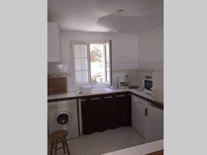 a white kitchen with a sink and a dishwasher at Appartement Citadelle in Corte