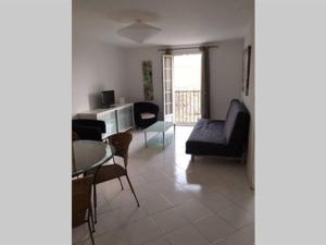 a living room with a couch and a table and chairs at Appartement Citadelle in Corte