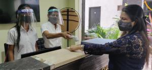 a woman in a mask is cutting a piece of wood at Nitya Resort, Calangute in Calangute +69 photos