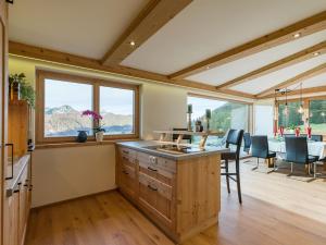 a kitchen and dining room with a table and chairs at Panorama Lodge in Walchsee