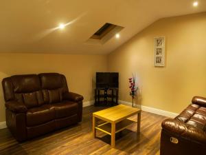 a living room with a couch and a table at Hillview Self Catering in Lusk