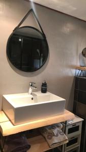 a bathroom with a white sink and a mirror at Chambre et Table d'hôtes Magaadjukalo in Saint-Maurice-de-Lignon +18 photos