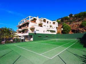 a tennis court in front of a building at Apartment Las Alondras-2 by Interhome in Roses
