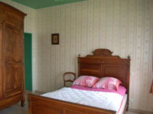 Un dormitorio con una cama con almohadas rosas. en Leval, en Trefcon