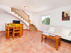 a living room with a couch and a table at Villa Villa Mimosa II by Interhome in Les tres Cales