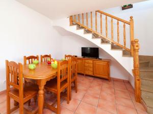 uma sala de jantar com uma mesa e cadeiras e uma escadaria em Villa Mimosa II by Interhome em Les tres Cales