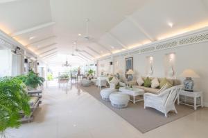 a living room with couches and chairs and tables at Kantary Bay Hotel Phuket in Panwa Beach