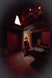 a man standing in a bathroom with a sink at Munjoh Ocean Resort - Private Beachfront Luxury Retreat in Havelock in Havelock Island
