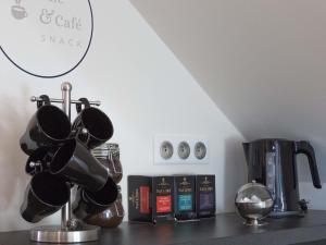 a counter top with a coffee pot and a coffee maker at La Dolce Vita in Fouesnant