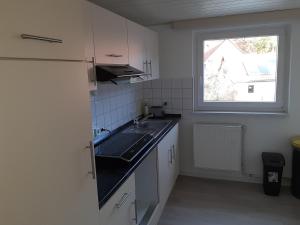 a small kitchen with a sink and a window at Landhaus Luttum in Kirchlinteln