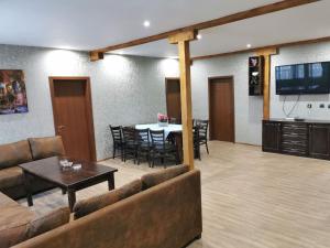 a living room with a couch and a table at Къща за гости ЕКО in Tsigov Chark
