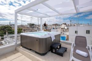a hot tub on the balcony of a building at Dama Bianca Boutique Hotel Ostuni in Ostuni