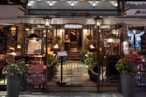 a store front with potted plants in front of it at Kamienica Goldwasser in Gdańsk