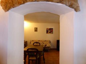 a dining room with a table and a couch at Captivating 1-Bed Apartment in Iglesias Sardinia in Iglesias