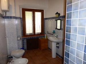 
a bathroom with a sink, toilet and tub at Captivating 2-Bed Apartment in Iglesias sailing in Iglesias
