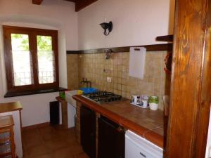 
a kitchen with a stove top oven and a sink at Captivating 2-Bed Apartment in Iglesias sailing in Iglesias
