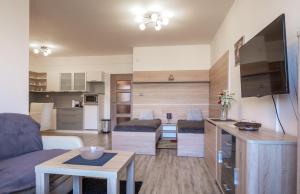 a living room with a couch and a table at TATRYSTAY Apartments Tatranska in Veľká Lomnica