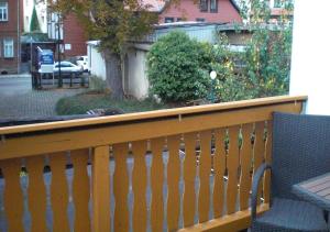 a wooden deck with a bench on a balcony at Ferienwohnung Schöne Ecke in Wernigerode +2 photos