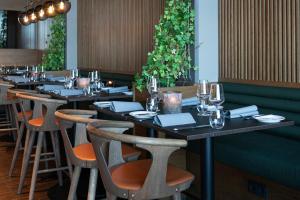 a row of tables in a restaurant with wine glasses at Quality Hotel Ålesund in Ålesund