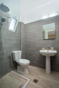 a bathroom with a toilet and a sink at Rosie's Bellezza in Faliraki