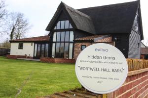 a sign in front of a house at Wortwell Hall Barn in Harleston