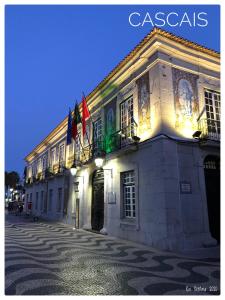 a building with flags on the side of it at Hotel Londres Estoril / Cascais in Estoril