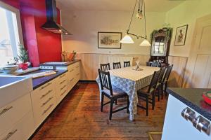 a kitchen with a table and chairs in a kitchen at Haus Schneider Kätchen in Deudesfeld