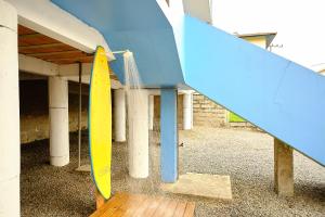 a group of surfboards hanging from a building at Apartamento primeiro andar in Garopaba