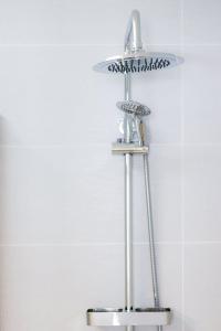a metal shelf in a bathroom with a shower at Casas do Torreão 3 casas de alojamento local in Alfaiates +103 photos